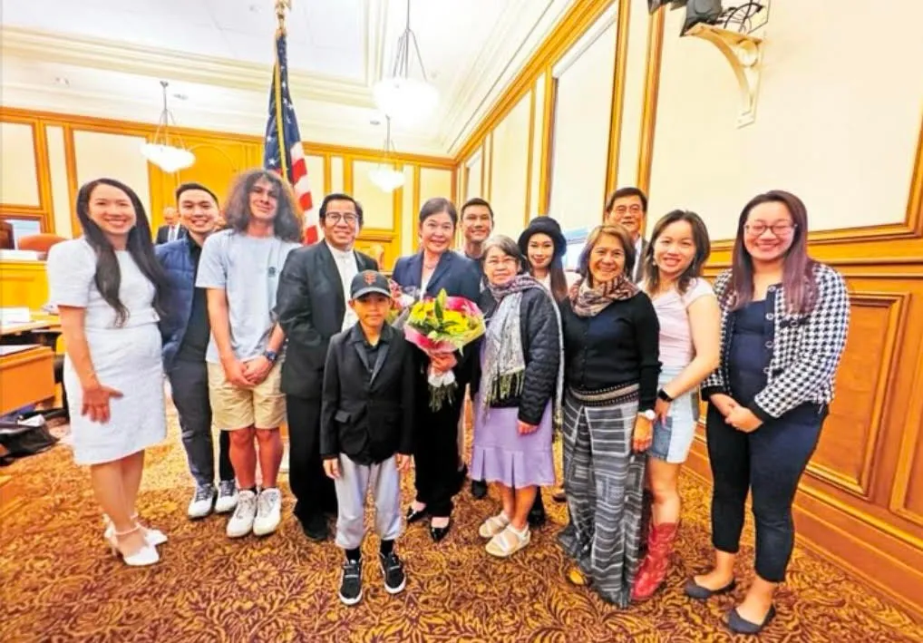 Monthanus Ratanapakdee with community members at an event inside San Francisco City Hall
