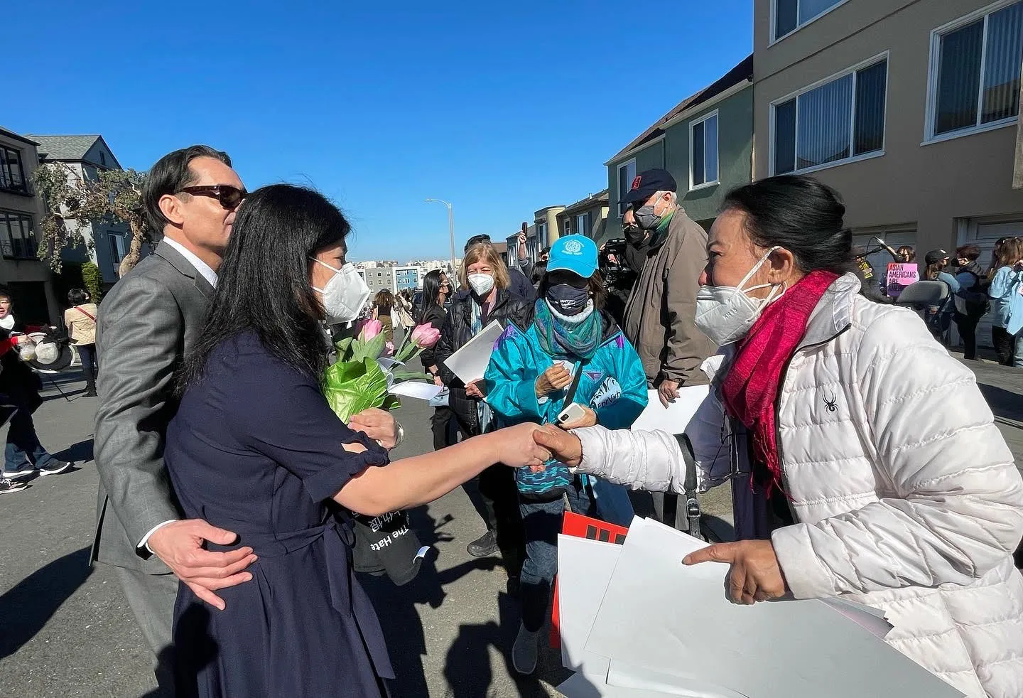 Monthanus Ratanapakdee greeting a community member in the neighborhood